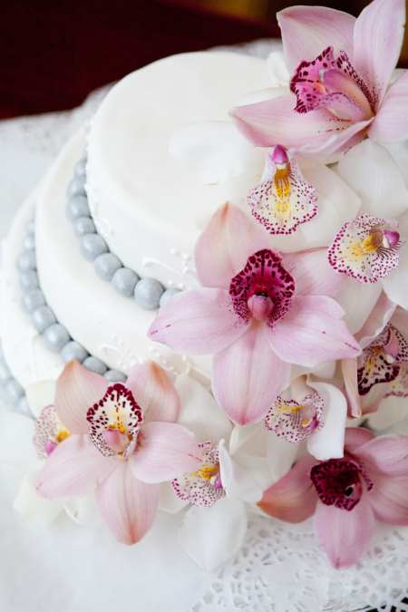 Orchid, lavender, yellow flowers on wedding cake