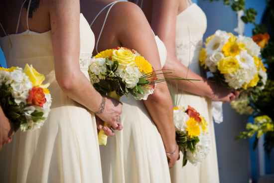 Yellow, orange white bridesmaids bouquets
