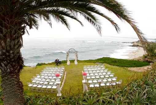 Seaside wedding setting with pink floral touches